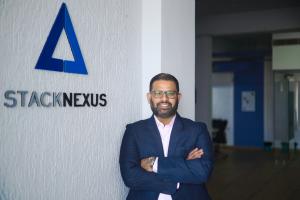 Suman Akula, CEO of StackNexus, is pictured in front of his company's logo.