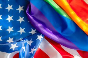 This image is a blend of the U.S. flag and the LGBT pride flag.