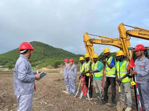 A Chinese manager is giving the instruction to a local team in front of the China-imported machinery.