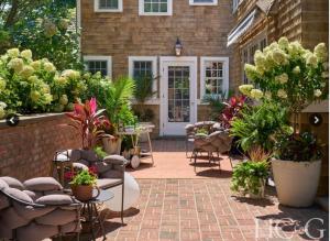 HC&G's coverage of the 2022 Hampton Designer Showhouse, where Lori Miller designed an outdoor living space with a “French Countryside in The Hamptons” theme that welcomed guests onto a brick terrace with furnishings from Ligne Roset and lighting by Bevolo