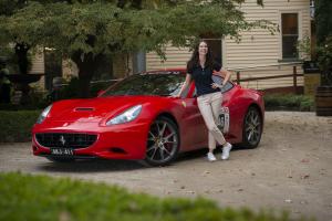 Julie Hunter shown with a luxury vehicle, shares travel trends for 2024