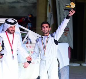 Khaled Al Feraihi shows off his 1st place trophy in the National category at the Dubai International Baja; he also took 3rd place in GCC.
