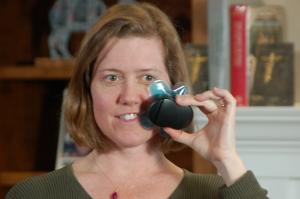 Woman holding Buzzy in place at lower jaw line