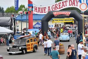 Cool looking woody hot rod rolling through a large crowd at the Washington State Fairgrounds.