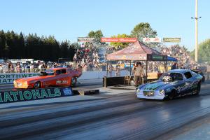 Vintage funny cars getting ready to launch off the starting line.