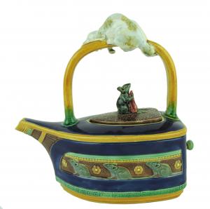 Minton Majolica cobalt teapot, modeled as a flat iron with a frieze of mice to the sides and a large white cat wrapped around the handle looking down at a mouse (est. $20,000-$25,000).