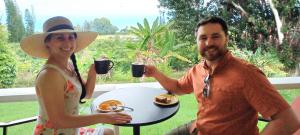 Farm tour guests enjoy Kona coffee on the lanai overlooking the Pacific ocean