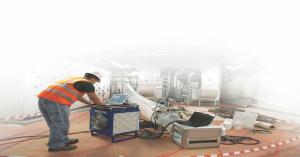 An image of a worker sealing a commercial building using Aeroseal's patented technology.