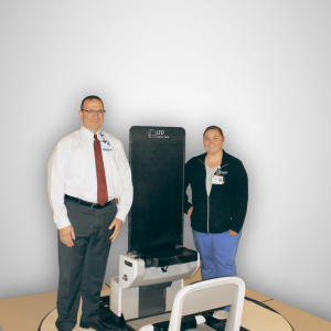 Vahagn Nazaryan, Executive Director and Stephanie Tucker, Radiation Therapist at McLaren Proton Therapy Center with the newly installed upright positioning system from Leo Cancer Care