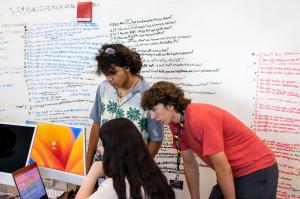 A team of students works together to identify a problem they want to solve with their business.