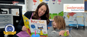 ACE staff reading Pete the Cat with child at a table