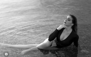 Katherine Vollen poses in a one piece swimsuit submerged in water