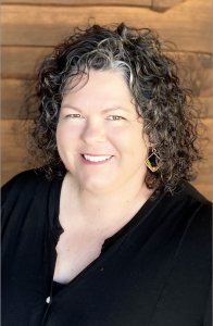 A headshot of Benina Montes, managing partner of Burroughs Family Farms
