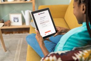 A patient using the Clinitouch remote patient monitoring app at home