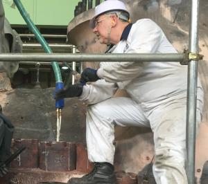 technician using induction heating for boiler tube removal