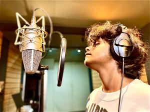 This is an image of the artist Upamanyu Mukherjee during recording in a studio