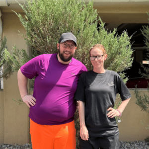 two staff members (man and woman) outside smiling at Best Western Plus Clocktower Inn