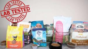 Lineup of cat foods on a coffee table with "Lab Tested" stamp