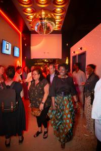 Disco ball ceiling, wall art, diverse and excited crowd enjoy the gallery and Cafe de Artistes at Brooklyn Art Haus