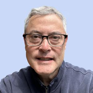 Head Shot of Brendan O'Leary with plain blue background