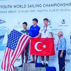 USA youth sailor James Pine of South Carolina stands atop winners podium in Volos, Greece after winning the recent 2023 ILCA-4 world 16-and-under sailing championship.