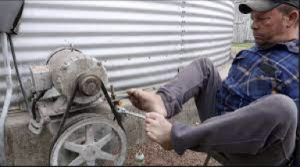 This farmer lost his arms at age two and a half.  He spent his life farming and working on equipment such as this blower on a grain bin