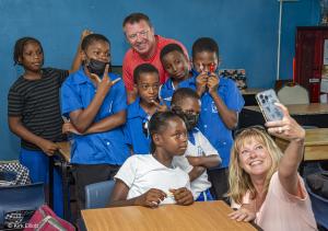 Students posing with tourists who visited an elementary school in Saint Lucia