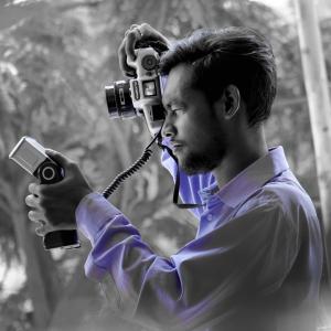 "Renowned photographer Jacob Xavier Selvaraj in his element, capturing the essence of life through his lens."