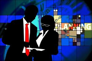 A man and woman in silhouette discuss business plans against a decorative mosiac background. Modern advice for modern men at https://HardTimesMakeStrongMen.com