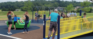 the community enjoying parks in Upper Allen Township. Parents and grandparents with children on playground