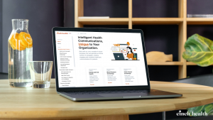 Cinch Health appears on the desktop of a laptop on an office desk