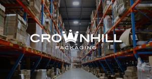 An image of an aisle in the Crownhill Packaging warehouse facility showcasing the new intelligent LED lighting upgrade, with the Crownhill Packaging logo placed over top.