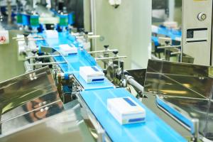 Serialized boxes of prescription drugs move across a manufacturing line