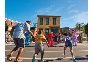 photo of family running towards Elmo at Sesame Street Land at SeaWorld Orlando