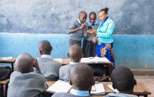 Teacher in Kenya Reading with Students on NABU app