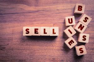 A group of wooden cubes spelling 'Selling a Business” as a concept applicable to both potential business buyers and sellers.