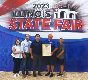 Emily McClelland, Matt McClelland, Jerry Costello II, Frank Doll, and Pam Doll with Prairie Farms' 85th anniversary proclamation.