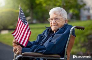 A veteran in a wheelchair with an American flag receiving home care from an agency that bills the Veterans Administration for care