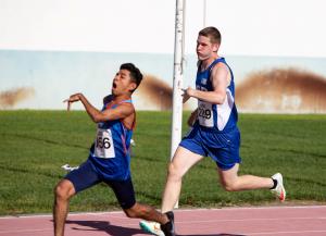 Two adaptive athletes competing in a track competition