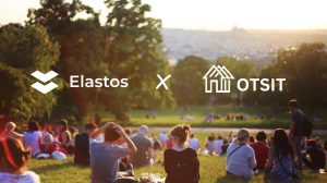 A group of people sitting in the park with OTSIT and Elastos logos superimposed.
