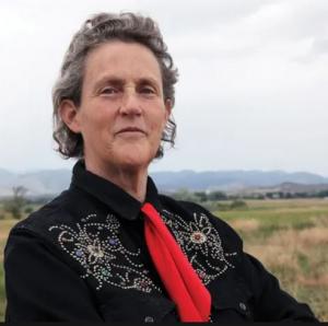 Dr. Temple Grandin wearing a western shirt with a red tie.