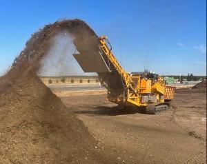 Agromin Merced truck dumpting soil.