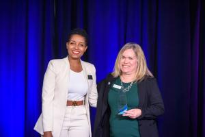 Marlyn Bonzil-Juste of Top Choice Medical Transport is presented with the NAWBO Orlando Emerging Business of the Year Award.