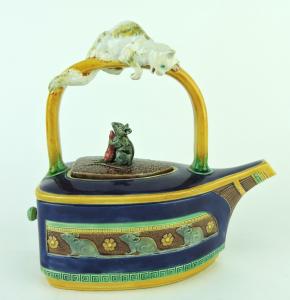 Minton cobalt teapot, modeled as a flat iron with a frieze of mice to the sides and a large white cat wrapped around the handle looking down at a mouse holding a carrot ($46,125).