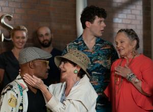 Tony Todd, Mercedes Ruehl and Nolan Gould in a still for The Nana Project. A older man and an older woman are interacting affectionately in the front while a young man stands behind