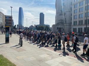 Pyjama skaters rolling past Blackfriars