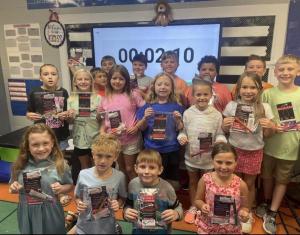 Group picture of students holding Carolina QuickCare gift bags