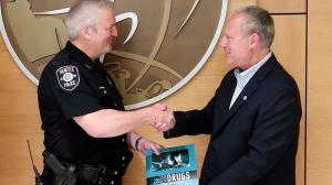 Dave Scattergood, Drug-Free World coordinator for Washington State, presented Capt. Strand with Drug-Free World materials for the department’s use in conducting drug education.