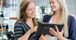 Rugged tablet being help by two women in retail