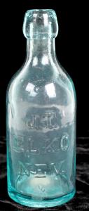 Aqua colored, circa 1870-1890 soda bottle from James Talbot, one of the pioneering soda water manufacturers in Nevada (“J.T. / Elko / Nev.”), with an applied top ($3,750).